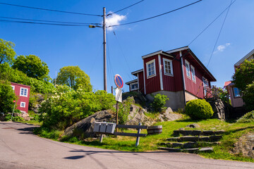 Picturesque colony of old small wooden historic houses on the Slottsberget mountain on the banks of the Gota alv river, Gothenburg, Sweden, sunny day