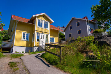 Picturesque colony of old small wooden historic houses on the Slottsberget mountain on the banks of the Gota alv river, Gothenburg, Sweden, sunny day