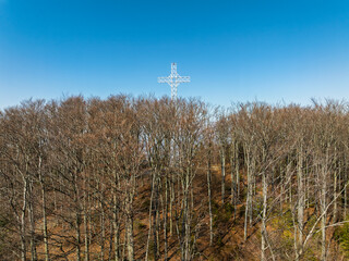Aerial drone view of beskid mountains in spring. Chrobacz Meadow peak in the Magurka Wilkowicka Group in the Little Beskids. Cross on a mountaintop in the Beskids..