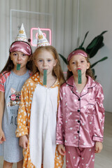 Three children, girls in pajamas. pajama party