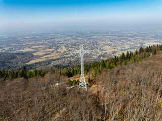 Aerial drone view of beskid mountains in spring. Chrobacz Meadow peak in the Magurka Wilkowicka Group in the Little Beskids. Cross on a mountaintop in the Beskids..
