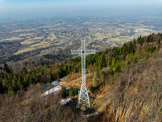 Aerial drone view of beskid mountains in spring. Chrobacz Meadow peak in the Magurka Wilkowicka Group in the Little Beskids. Cross on a mountaintop in the Beskids..