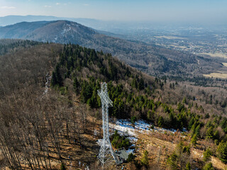 Aerial drone view of beskid mountains in spring. Chrobacz Meadow peak in the Magurka Wilkowicka Group in the Little Beskids. Cross on a mountaintop in the Beskids..