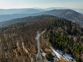 Aerial drone view of beskid mountains in spring. Chrobacz Meadow peak in the Magurka Wilkowicka Group in the Little Beskids. Cross on a mountaintop in the Beskids..