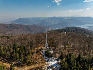 Aerial drone view of beskid mountains in spring. Chrobacz Meadow peak in the Magurka Wilkowicka Group in the Little Beskids. Cross on a mountaintop in the Beskids..