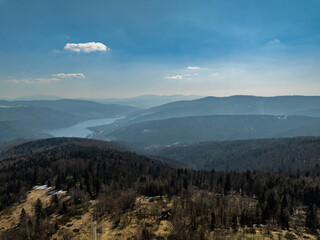 Aerial drone view of beskid mountains in spring. Chrobacz Meadow peak in the Magurka Wilkowicka Group in the Little Beskids. Cross on a mountaintop in the Beskids..