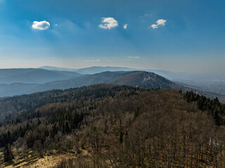 Aerial drone view of beskid mountains in spring. Chrobacz Meadow peak in the Magurka Wilkowicka Group in the Little Beskids. Cross on a mountaintop in the Beskids..