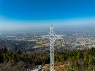 Aerial drone view of beskid mountains in spring. Chrobacz Meadow peak in the Magurka Wilkowicka Group in the Little Beskids. Cross on a mountaintop in the Beskids..