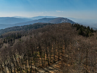 Aerial drone view of beskid mountains in spring. Chrobacz Meadow peak in the Magurka Wilkowicka Group in the Little Beskids. Cross on a mountaintop in the Beskids..