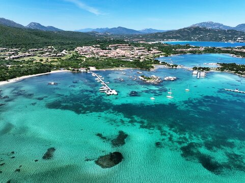 Aerial view of a white sand beach bathed by a beautiful turquoise sea. Marinella Beach, Porto Rotondo, Sardinia, Italy