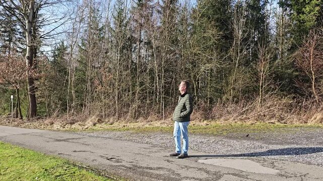 Mindfulness in the forest: Person breathes deeply and relaxes in nature &ndash; wellness and relaxation