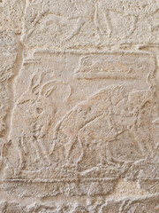 Ancient stone relief with images from ancient Egypt in the Giza pyramid complex