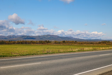Asphalt road in mountainous area. Sunny mountain landscape