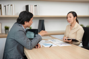 Professional Discussion and Strategy Planning. Business partners engaging in a meeting about financial goals.