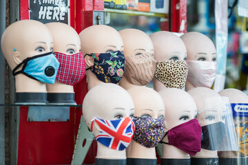 Cloth face masks displayed on mannequin heads on Wood Green high street, London, England