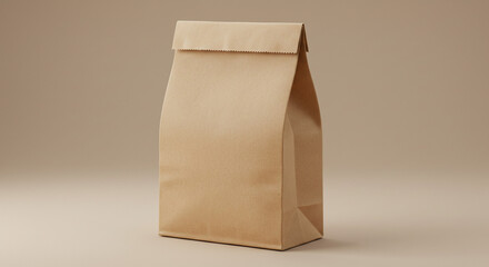 A simple brown paper bag standing upright on a beige surface with a folded top against a plain backdrop