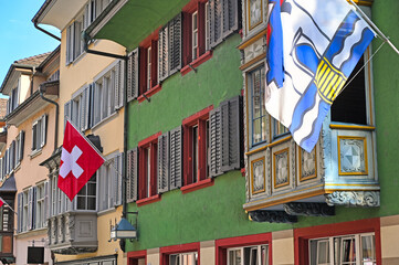 Street with swiss flags in the old town of Zurich