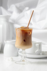 Iced coffee with cream and cup of black coffee.