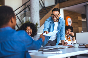 Smiling Team Collaborating Around a Table During a Business Meeting