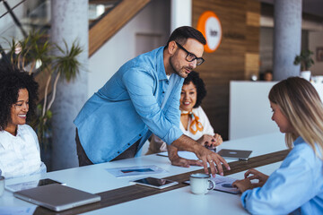 Professional Team Collaborating in Modern Office Setting During a Business Meeting