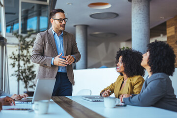 Business Team in Meeting Discussing Strategies in Modern Office Space