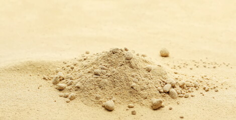 Yellow, golden maca organic powder background and texture, side view	