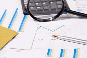 Calculator and Pen on Business Report &ndash; Representation of Economic Forecasting and Management