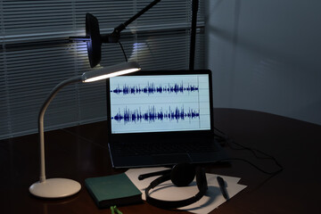 Set up listening and audio recording: a laptop with audio wave display, directional microphone,...