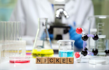 The laboratory scene prominently showcases nickel, numerous chemicals, and cuttingedge microscopy...
