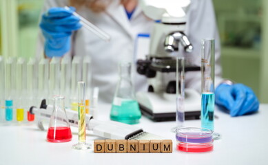Scientific exploration is occurring in a laboratory with colorful liquids and a microscope for...