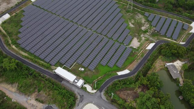 4K Aerial View of Industrial Factory with Solar Panels on Roof Producing Clean Energy