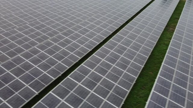 4K Aerial View of Industrial Factory with Solar Panels on Roof Producing Clean Energy