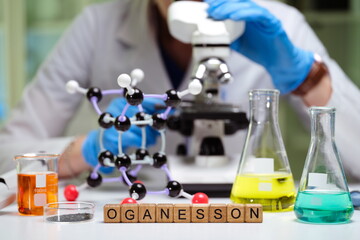 A scientist examines molecular structures and compounds related to Oganesson in a laboratory...
