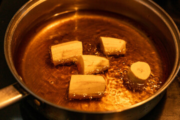 Plantains frying in a pan