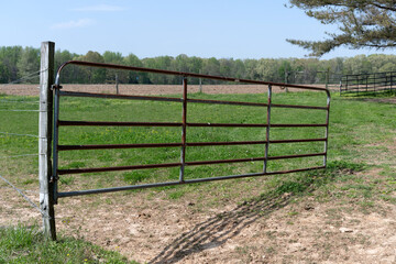 A rusty metal fence door in a Tennessee ranch