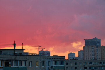Urban Skyline Silhouette with Cranes at Colorful Dusk