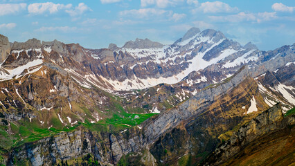 Majestic alpine landscape featuring rugged mountains and snow-capped peaks under a clear blue sky