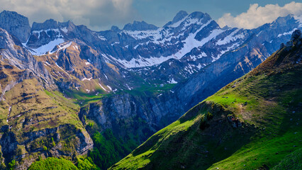 Breathtaking mountain landscape with snow-capped peaks and lush green valleys in a serene natural setting