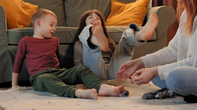 Happy family tickling and playing on living room floor
