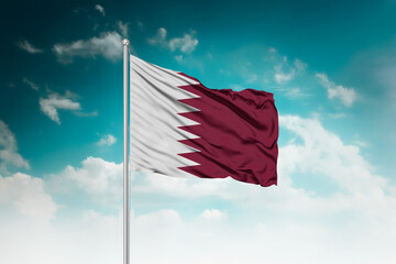 High-resolution stock image of a gently billowing Qatar national flag mounted on a modern flagpole...