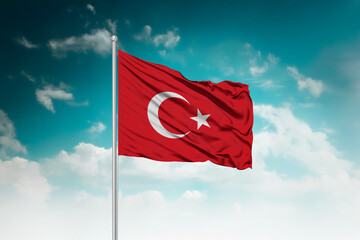 High-resolution stock image of a gently billowing Turkey national flag mounted on a modern flagpole...