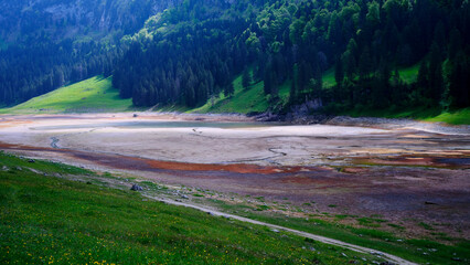 Dried riverbed reveals stunning vegetation and hills in summer landscape