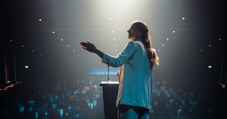 Beautiful Personal Growth Keynote Speaker Delivering a Motivational Speech on Stage, Hosting a...