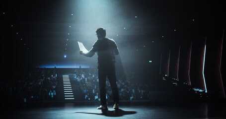 Open Lecture at an College Campus: Postgraduate College Student Making a Presentation to a Group of Students. Young Indian Man Reading From a Piece of Paper, Giving Advice on Career Opportunity