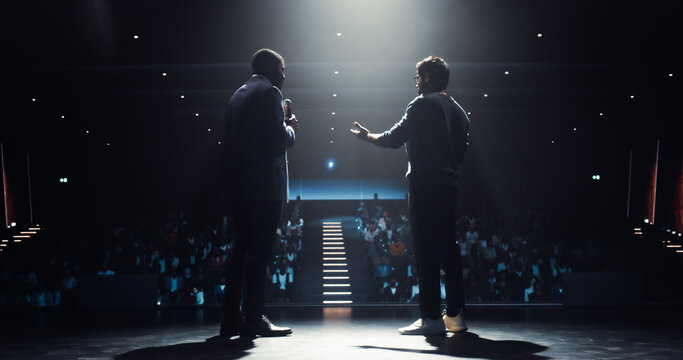 Q&A Session on Stage at a Business Conference. African Host Interviewing a Young Successful Indian Entrepreneur, Presenting the Speaker to the Audience, Asking About His Career Path