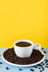 White Cup of Black Coffee with Roasted Beans on Solid Colored Background for Creative Branding