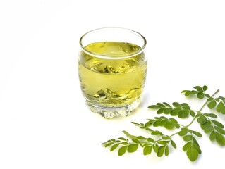 Boiled moringa leaves water in glass on white background. Healthy drink lifestyle
