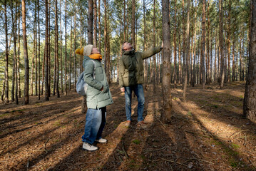 Fototapeta premium Dad And Daughter Walking In The Forest In Spring