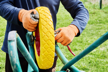 Solid polyurethane wheel provides durability and puncture resistance while maintenance worker...