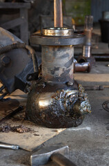 Fototapeta premium Greasy Drivetrain Component: Automotive Maintenance in Workshop